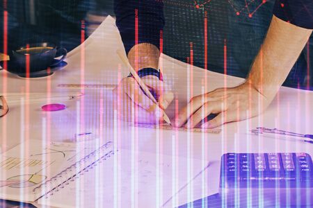 Double exposure of man writing on paper with forex graph.