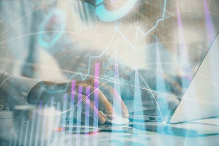 Double exposure of forex graph with man working on computer on background. Concept of market analysis.の写真素材