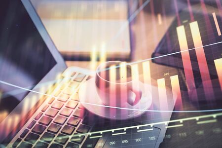 Stock market graph and table with computer background. Double exposure. Concept of financial analysis.の写真素材
