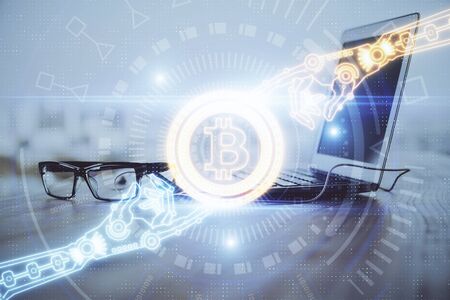 Multi exposure of blockchain theme hologram and table with computer background. Concept of bitcoin...