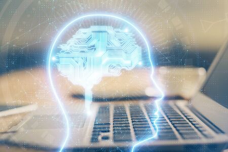 Double exposure of table with computer and brain hologram. Data innovation concept.
