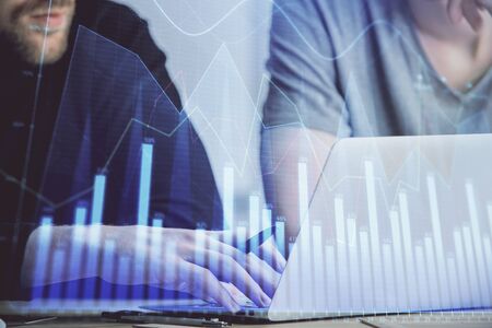Forex graph with businessman typing on computer in office on background. Concept of analysis. Double exposure.の写真素材