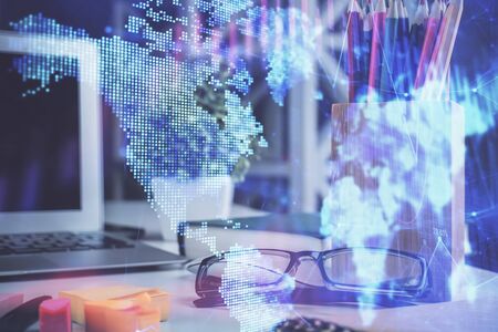 Financial chart hologram with glasses on the table background. Concept of business. Double exposure.の写真素材