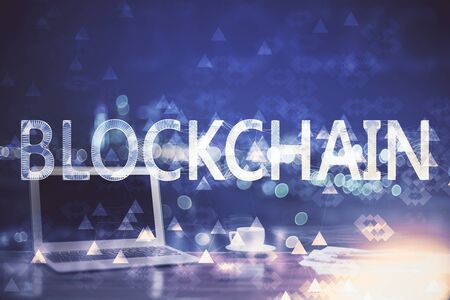 Multi exposure of blockchain theme hologram and table with computer background. Concept of bitcoin crypto currency.の写真素材