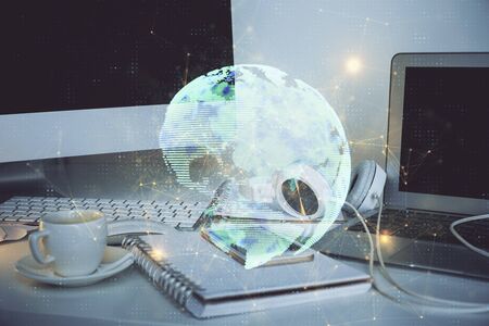 Computer on desktop with social network theme icon. Multi exposure. Concept of international connections.の写真素材