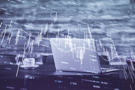 Forex market chart hologram and personal computer background. Double exposure. Concept of investment.の写真素材