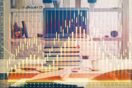 Financial graph colorful drawing and table with computer on background. Double exposure. Concept of international markets.の写真素材