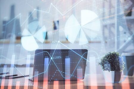 Forex Chart hologram on table with computer background. Double exposure. Concept of financial markets.の写真素材
