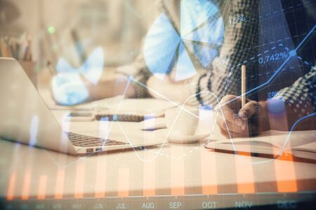 Multi exposure of forex chart with man working on computer on background. Concept of market analysis.の写真素材