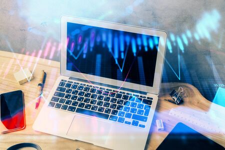 Multi exposure of chart and financial info and work space with computer background. Concept of international online trading.の写真素材