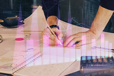 Double exposure of man writing on paper with forex graph.の写真素材