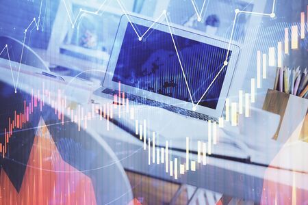 Forex market graph hologram and personal computer on background. Double exposure. Concept of...