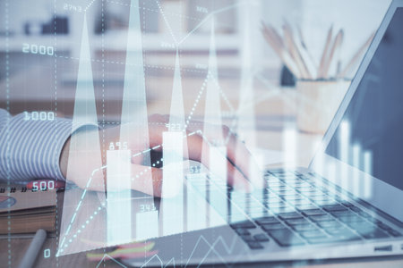Multi exposure of market chart with man working on computer on background. Concept of financial analysis.の写真素材