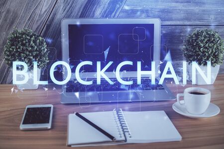 Multi exposure of blockchain theme hologram and table with computer background. Concept of bitcoin...