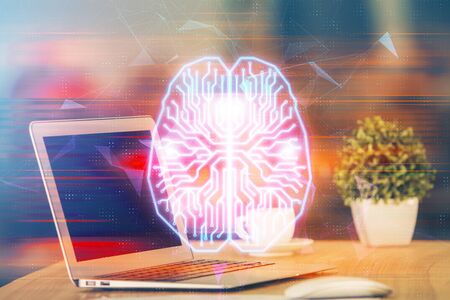 Double exposure of table with computer and brain hologram. Data innovation concept.