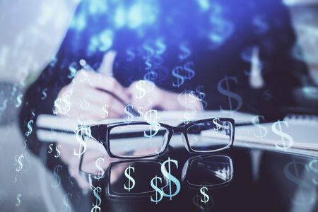 Forex chart hologram on hand taking notes background. Concept of analysis. Double exposureの写真素材