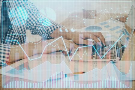 Multi exposure of stock market chart with man working on computer on background. Concept of financial analysis.の写真素材