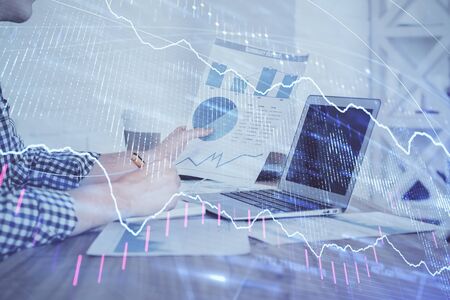 Multi exposure of financial graph with man works in office on background. Concept of analysis.