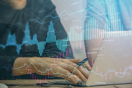 Forex graph with businessman typing on computer in office on background. Concept of analysis. Double...