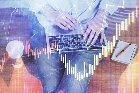 Forex graph with businessman working on computer in office on background. Concept of analysis....
