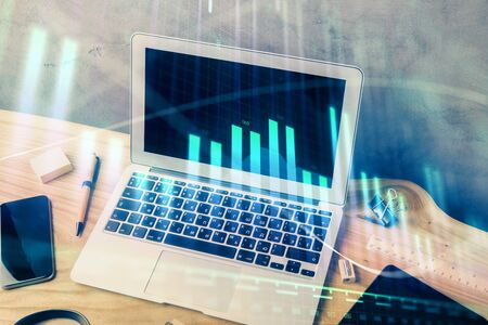 Multi exposure of graph and financial info and work space with computer background. Concept of international online trading.の写真素材