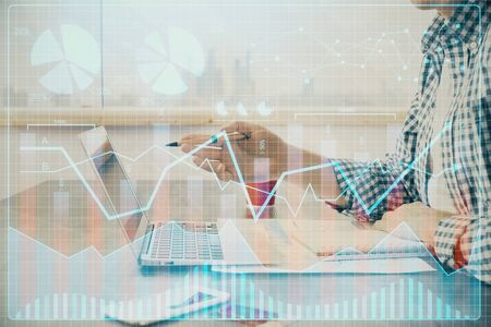 Multi exposure of stock market chart with man working on computer on background. Concept of...