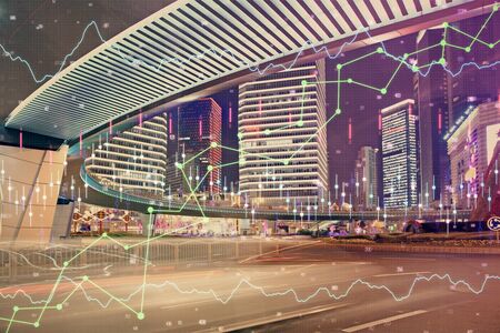 Forex chart on cityscape with tall buildings background multi exposure. Financial research concept.の写真素材