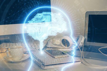 Double exposure of table with computer and brain hologram. Data innovation concept.