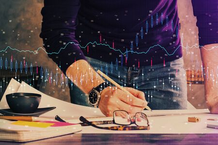 Double exposure of man writing on paper with forex graph. Concept of research and trading.の写真素材