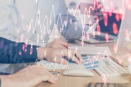 Multi exposure of chart with man typing on computer in office on background. Concept of hard work.の写真素材