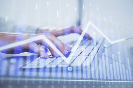 Forex graph with businessman working on computer in office on background. Concept of hardworking. Closeup. Multi exposure.の写真素材