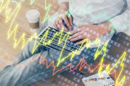 Forex graph with businessman working on computer in office on background. Concept of analysis....