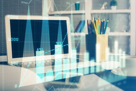 Stock market graph and table with computer background. Double exposure. Concept of financial analysis.の写真素材