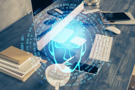 Double exposure of table with computer and brain hologram. Data innovation concept.