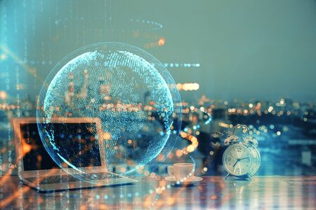 Multi exposure of table with computer and world map hologram. International data network concept.の写真素材