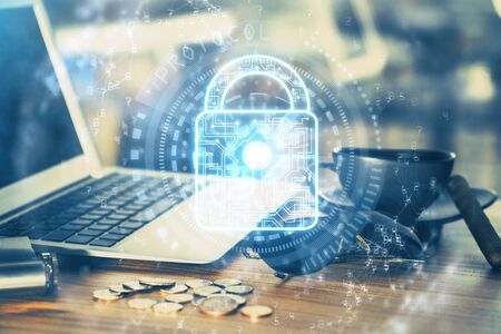 Double exposure of desktop with computer and lock icon hologram. Concept of data safety.の写真素材