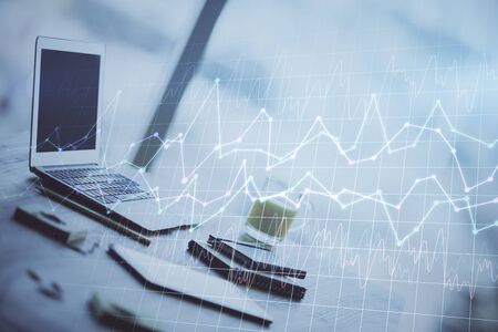 Forex market chart hologram and personal computer background. Multi exposure. Concept of investment.の写真素材