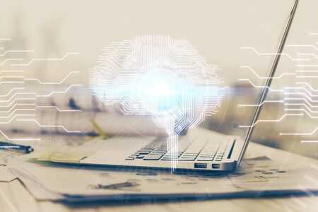 Multi exposure of work table with computer and brain hologram. Brainstorm concept.