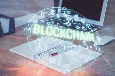 Double exposure of blockchain theme hologram and table with computer background. Concept of bitcoin...