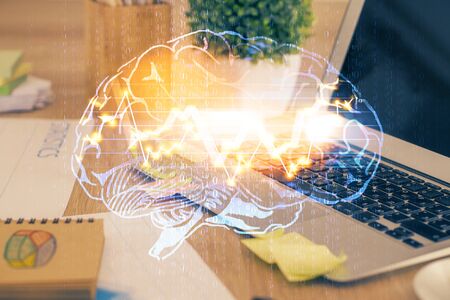 Double exposure of table with computer and brain hologram. Data innovation concept.