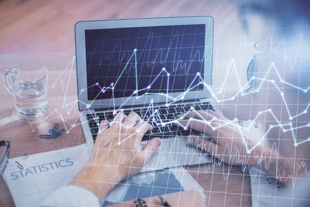 Multi exposure of forex graph with man working on computer on background. Concept of market analysis.の写真素材