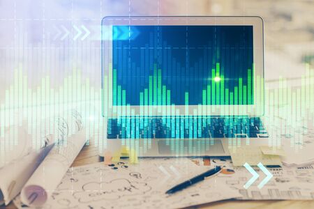 Forex market graph hologram and personal computer on background. Double exposure. Concept of...