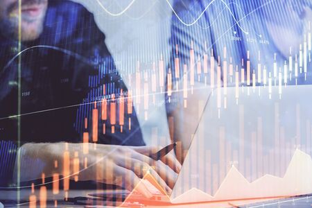 Forex graph with businessman typing on computer in office on background. Concept of analysis. Double...