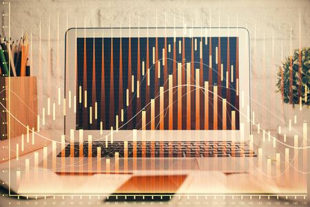 Forex market chart hologram and personal computer background. Double exposure. Concept of investment.の写真素材