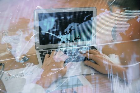 Multi exposure of market chart with man working on computer on background. Concept of financial analysis.の写真素材