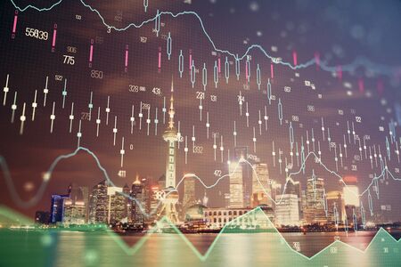 Financial graph on night city scape with tall buildings background multi exposure. Analysis concept.の写真素材