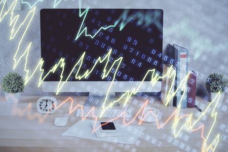 Forex graph hologram on table with computer background. Double exposure. Concept of financial...