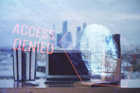 Computer on desktop in office with finger print drawing. Double exposure. Concept of business data security.の写真素材