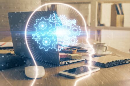 Double exposure of work table with computer and brain sketch hologram. Brainstorming concept.