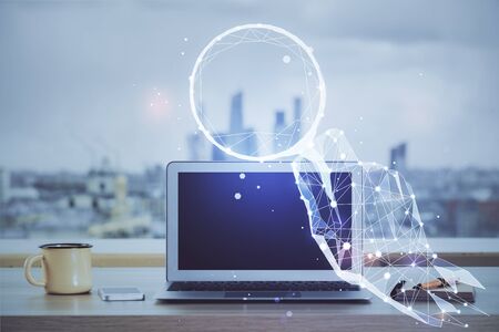 Desktop computer background in office and start up theme hologram drawing. Double exposure. Startup concept.の写真素材
